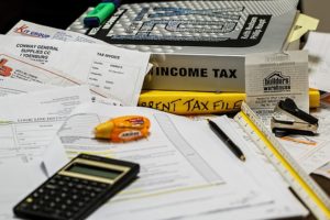 a pile of supplies to do taxes - Dan Moisand discusses how to manage investment taxes